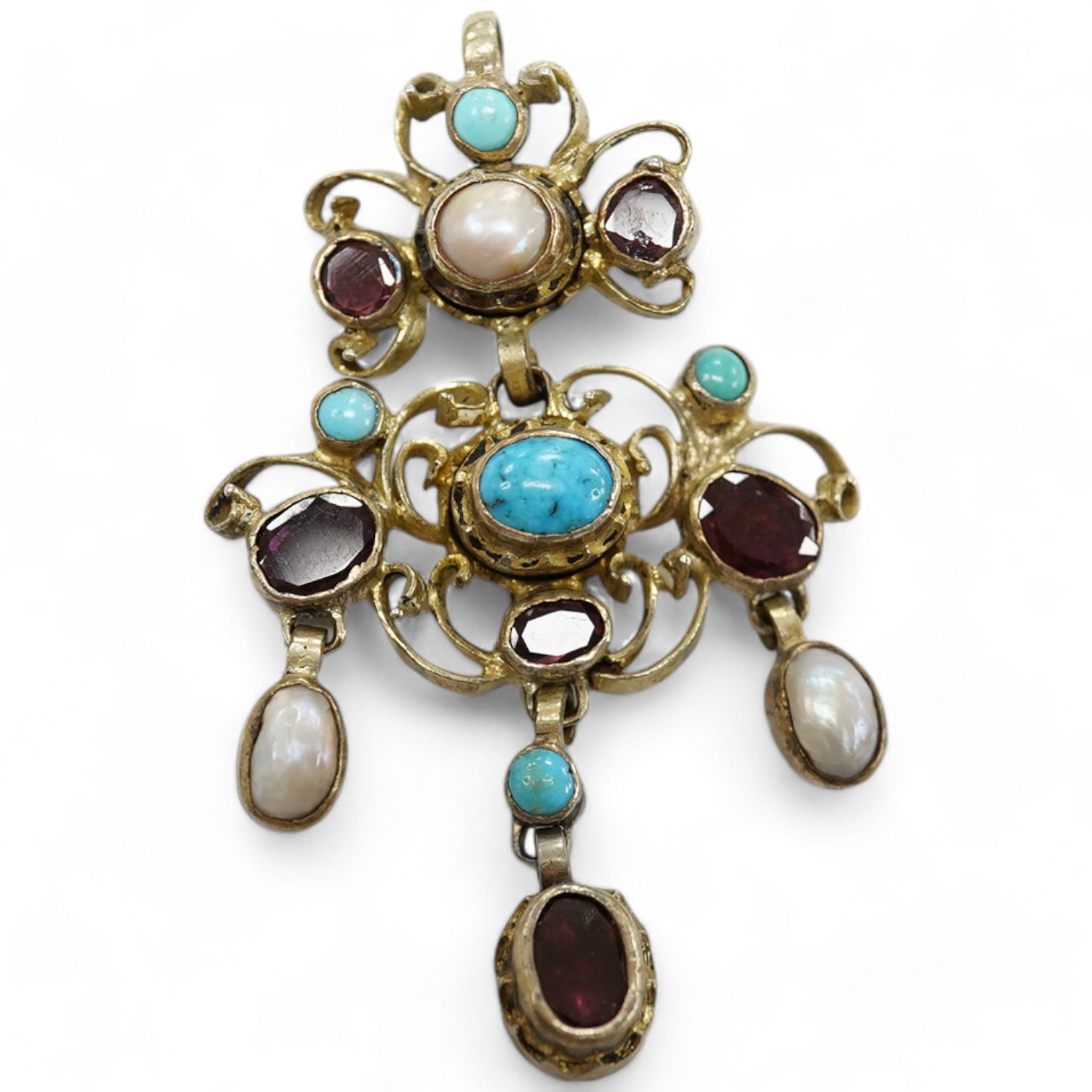 A 19th century Austro-Hungarian? gilt white metal, turquoise, garnet and split pearl set drop pendant, 53mm. Condition - poor to fair